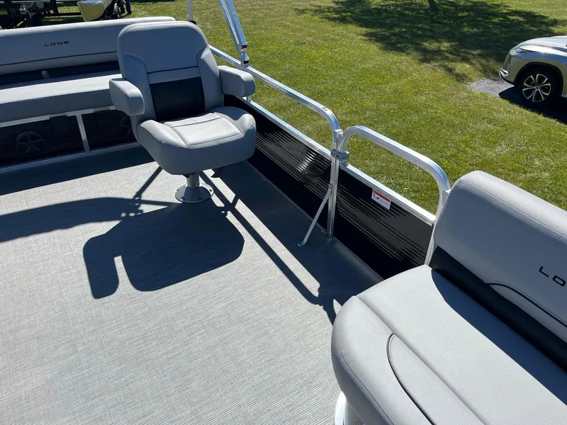 Slide: The Image of 2024 Lowe Ultra 160 Cruise pontoon boat interior with seating and railing. - 15
