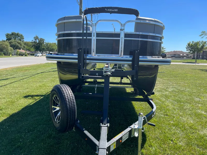 Slide: The Image of 2024 Lowe Ultra 160 Cruise pontoon boat on a trailer, front view. - 2