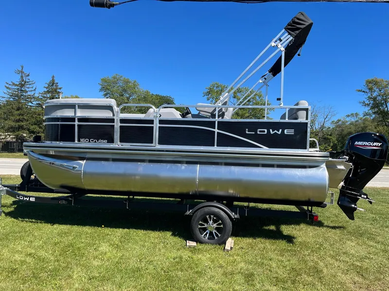 Slide: The Image of 2024 Lowe Ultra 160 Cruise pontoon boat on trailer with Mercury outboard motor. - 3