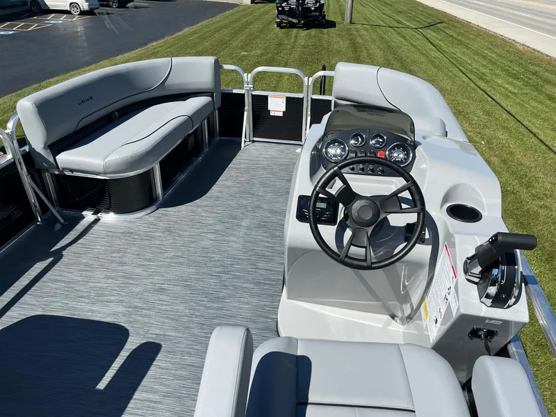 Slide: The Image of 2024 Lowe Ultra 160 Cruise pontoon boat interior with steering console and seating. - 6