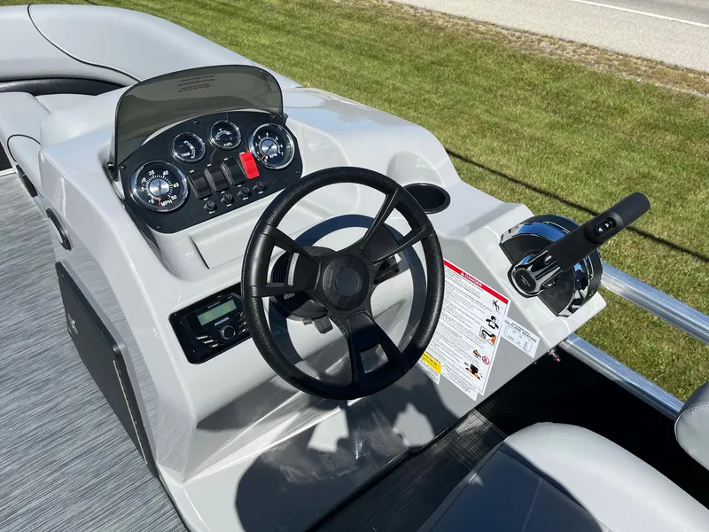 Slide: The Image of 2024 Lowe Ultra 160 Cruise boat dashboard with steering wheel and control panel. - 7