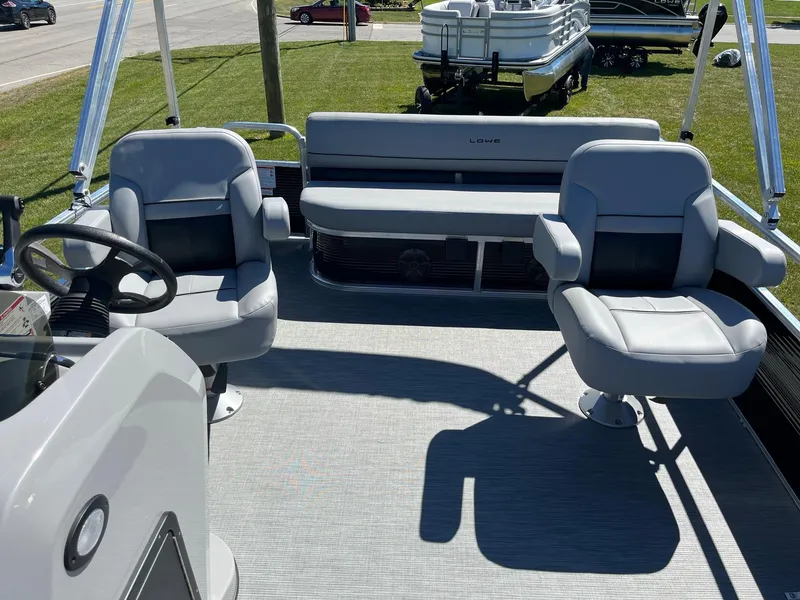 Slide: The Image of 2024 Lowe Ultra 160 Cruise pontoon boat interior with seating and steering console. - 8