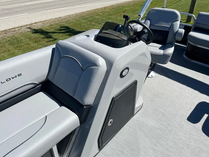 Slide: The Image of 2024 Lowe Ultra 160 Cruise boat interior with steering console and seating. - 9