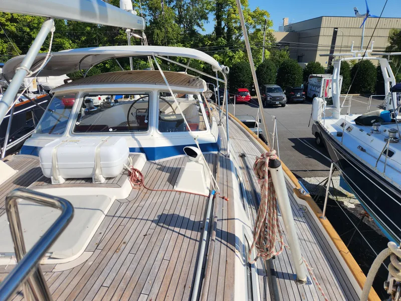 Slide: The Image of 2006 Hallberg-Rassy 53 yacht with teak deck, docked in a marina. - 14