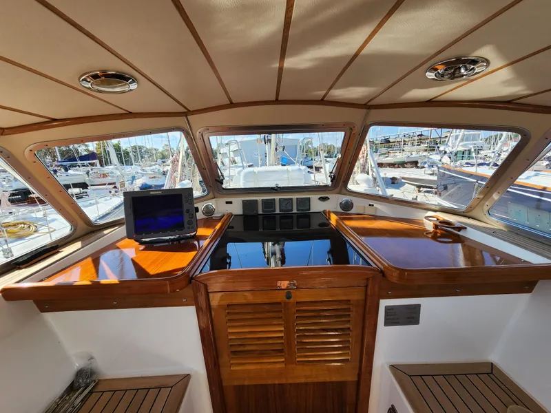 Slide: The Image of 2006 Hallberg-Rassy 53 yacht interior with polished wood and navigation equipment. - 15