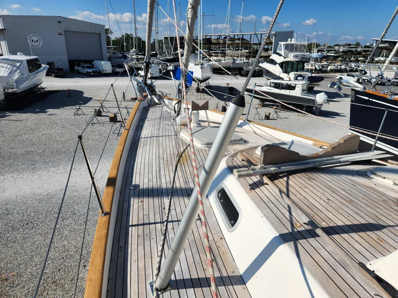 Slide: The Image of Deck view of 2006 Hallberg-Rassy 53 sailboat in a marina setting. - 16