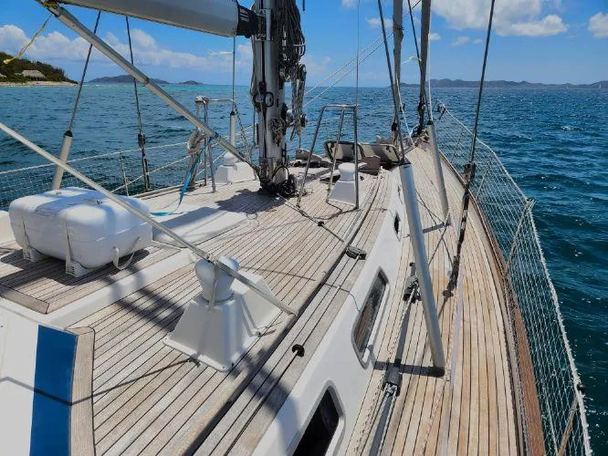 Slide: The Image of 2006 Hallberg-Rassy 53 sailboat deck with ocean view and clear skies. - 28