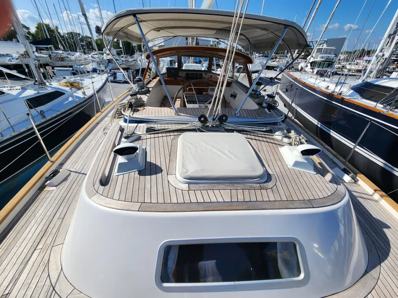 Slide: The Image of 2006 Hallberg-Rassy 53 sailboat deck with canopy, docked in a marina. - 29