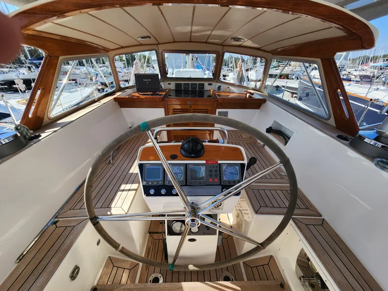 Slide: The Image of Cockpit of 2006 Hallberg-Rassy 53 yacht with wooden accents and steering wheel. - 3