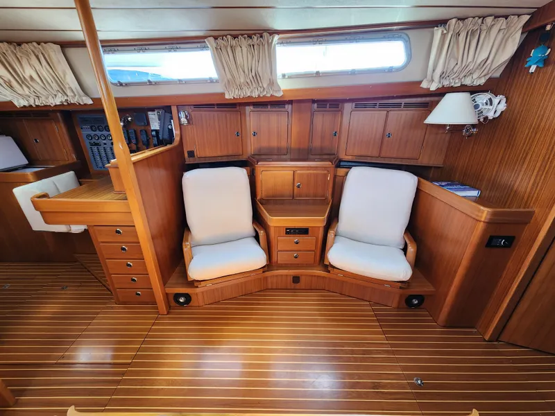 Slide: The Image of Interior of 2006 Hallberg-Rassy 53 yacht with wooden cabinetry and cushioned seating. - 30