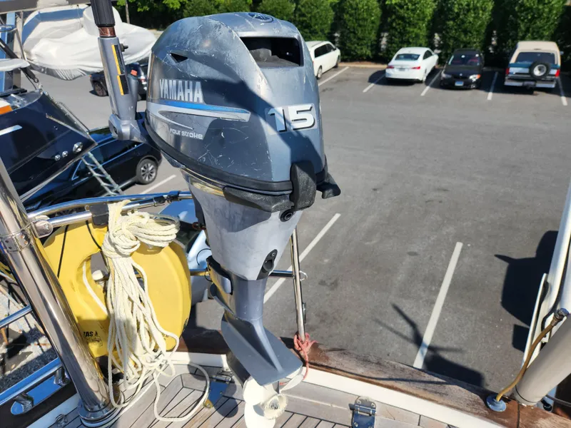 Slide: The Image of Yamaha 15 outboard motor on 2006 Hallberg-Rassy 53 sailboat, docked in parking lot. - 33