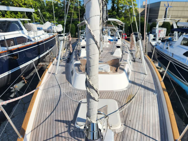 Slide: The Image of Deck view of a 2006 Hallberg-Rassy 53 sailboat in a marina. - 36