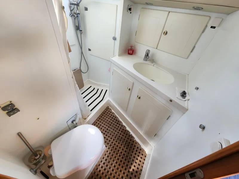 Slide: The Image of Bathroom interior of a 2006 Hallberg-Rassy 53 yacht, featuring sink, toilet, and shower. - 37