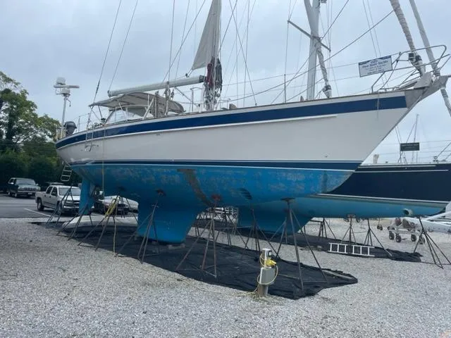 Slide: The Image of 2006 Hallberg-Rassy 53 sailboat on dry dock, blue hull, white deck, supported by stands. - 39