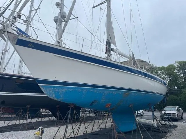Slide: The Image of 2006 Hallberg-Rassy 53 sailboat on stands, blue hull, marina setting. - 40