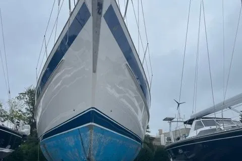 Slide: The Image of 2006 Hallberg-Rassy 53 sailboat on land, showcasing its hull and keel. - 41