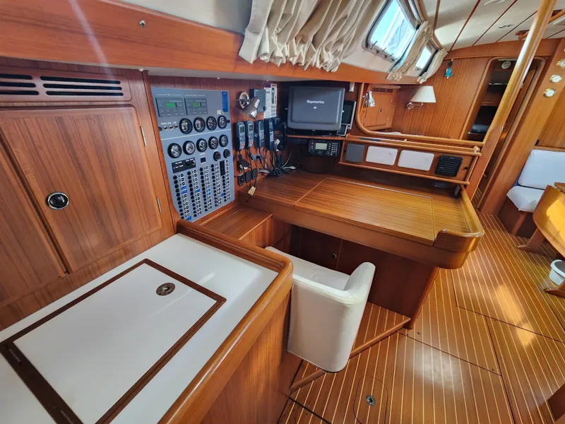 Slide: The Image of Interior of 2006 Hallberg-Rassy 53 yacht with navigation station and wooden finish. - 5
