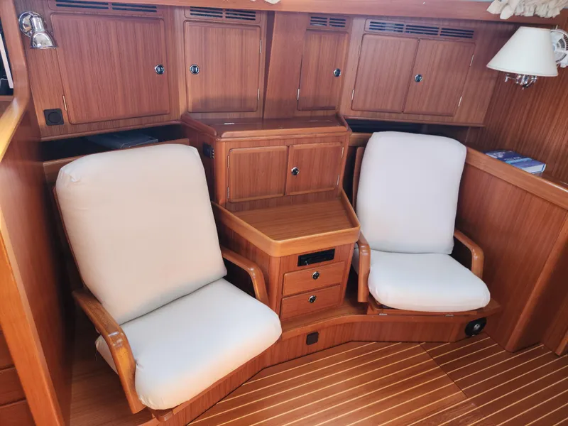Slide: The Image of Interior of 2006 Hallberg-Rassy 53 yacht with wooden cabinetry and cushioned seating. - 6