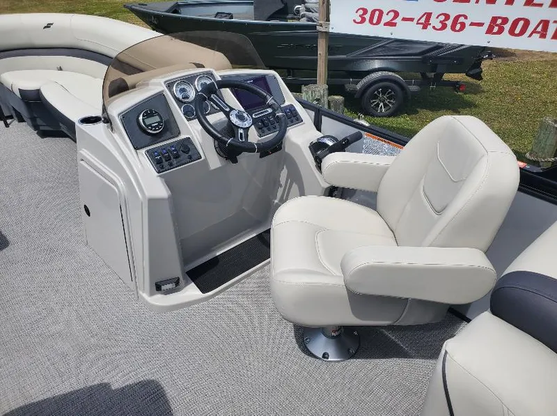 Slide: The Image of Captain's seat and helm of 2023 Starcraft EXS-5 boat, featuring modern controls and comfortable seating. - 3