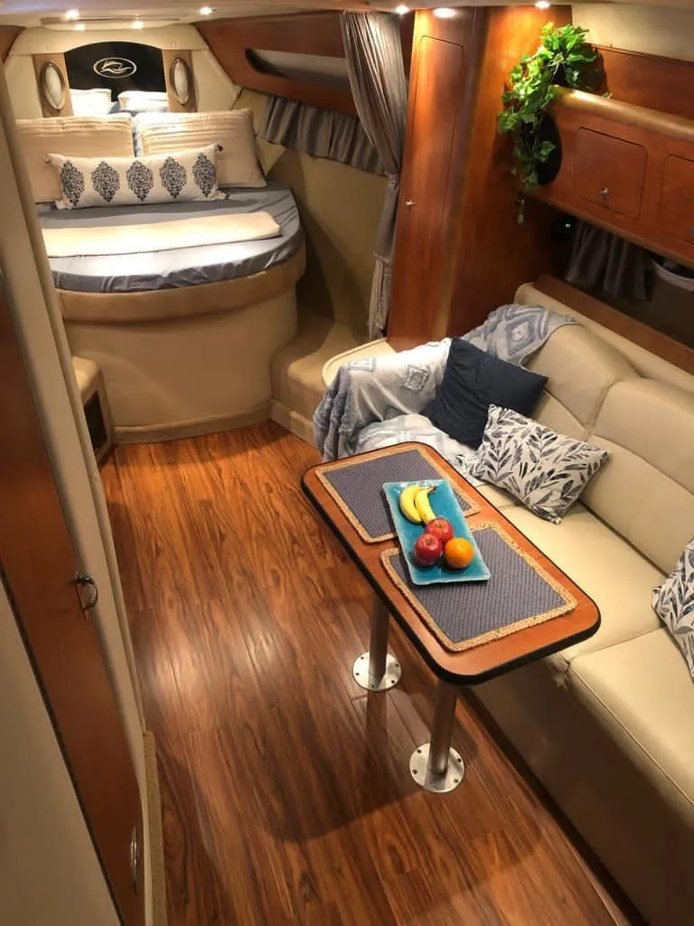 Slide: The Image of Interior of a 2008 Rinker 350 Express Cruiser with beige seating and wooden flooring. - 11