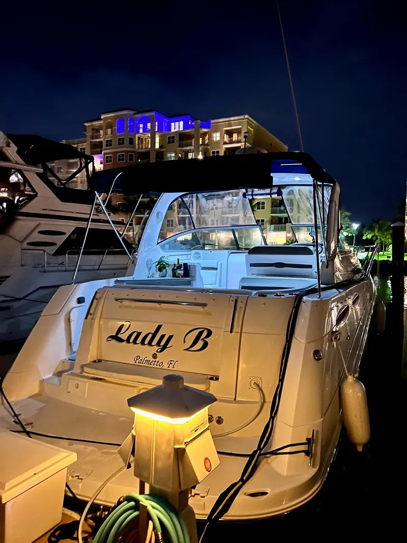 Slide: The Image of 2008 Rinker 350 Express Cruiser on dry dock, showing propellers and stern. - 14