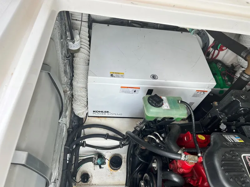 Slide: The Image of 2008 Rinker 350 Express Cruiser on calm water with clear blue sky. - 17