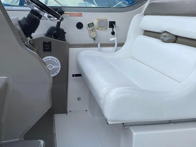Slide: The Image of 2008 Rinker 350 Express Cruiser helm seat and control panel. - 23