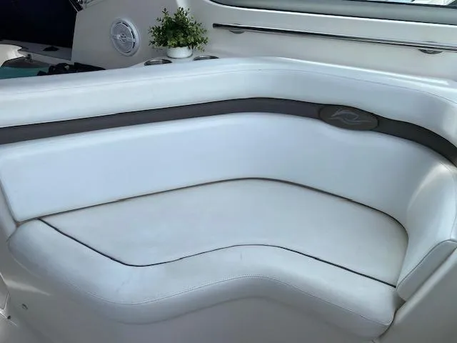 Slide: The Image of 2008 Rinker 350 Express Cruiser white leather seating area with small potted plant. - 24