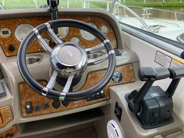 Slide: The Image of 2008 Rinker 350 Express Cruiser helm with steering wheel and control panel. - 26