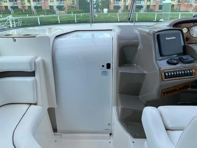 Slide: The Image of 2008 Rinker 350 Express Cruiser cockpit with seating and navigation equipment. - 27