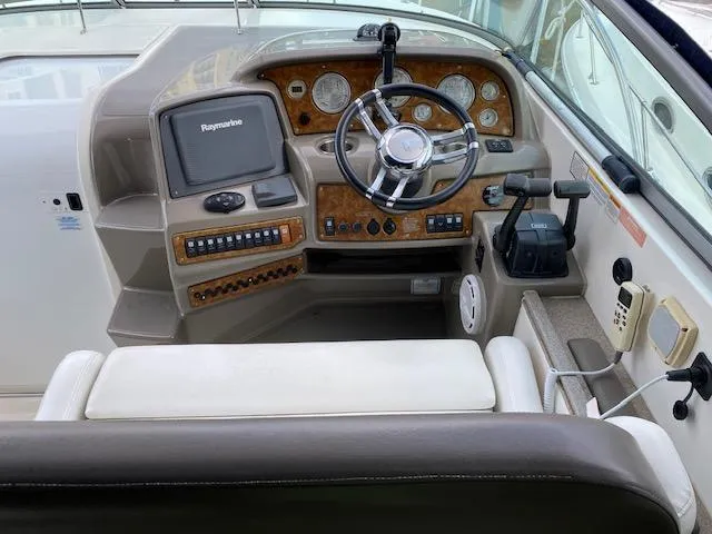 Slide: The Image of 2008 Rinker 350 Express Cruiser helm with Raymarine electronics and woodgrain dashboard. - 29