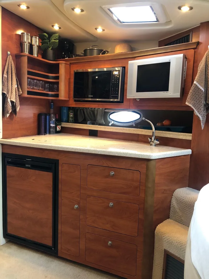 Slide: The Image of Interior of 2008 Rinker 350 Express Cruiser with sofa, table, and decorative pillows. - 7