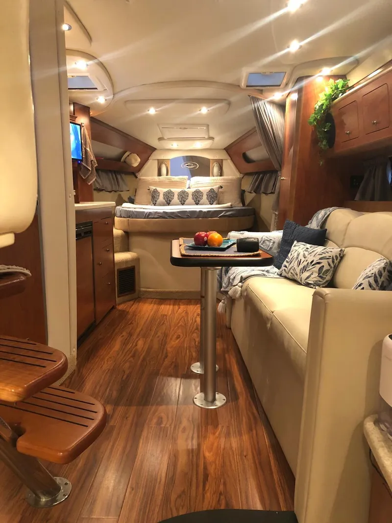 Slide: The Image of 2008 Rinker 350 Express Cruiser bathroom with sink, toilet, and storage cabinets. - 9