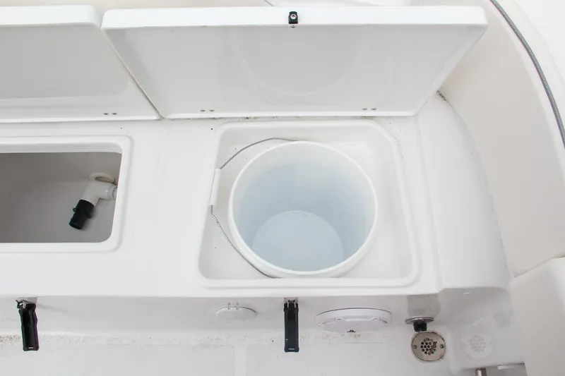 Slide: The Image of 2024 Sea Hunt Ultra 239 SE storage compartments and bucket. - 10