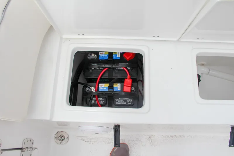 Slide: The Image of Battery compartment of 2024 Sea Hunt Ultra 239 SE boat with dual batteries. - 12