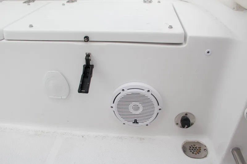 Slide: The Image of 2024 Sea Hunt Ultra 239 SE boat interior with speaker and storage compartment. - 13