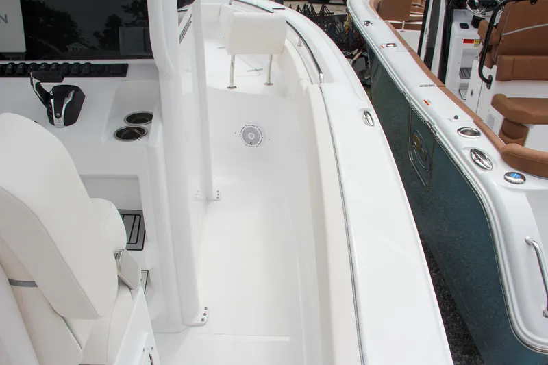 Slide: The Image of 2024 Sea Hunt Ultra 239 SE boat interior, white seating and console. - 17