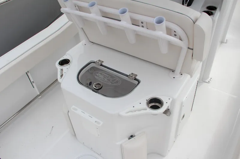 Slide: The Image of 2024 Sea Hunt Ultra 239 SE boat interior with rod holders and storage. - 18