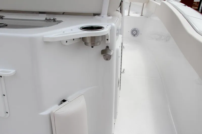 Slide: The Image of 2024 Sea Hunt Ultra 239 SE boat interior with cup holder and seating. - 21