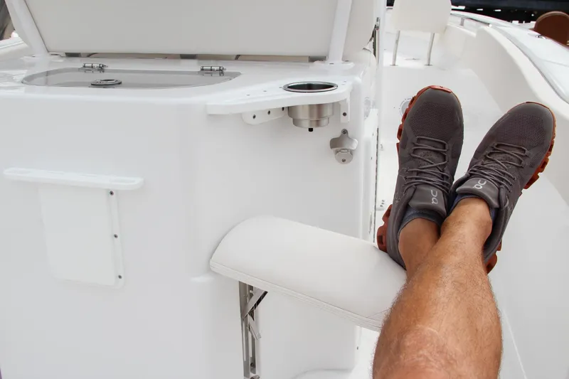 Slide: The Image of Man relaxing on a 2024 Sea Hunt Ultra 239 SE boat. - 22
