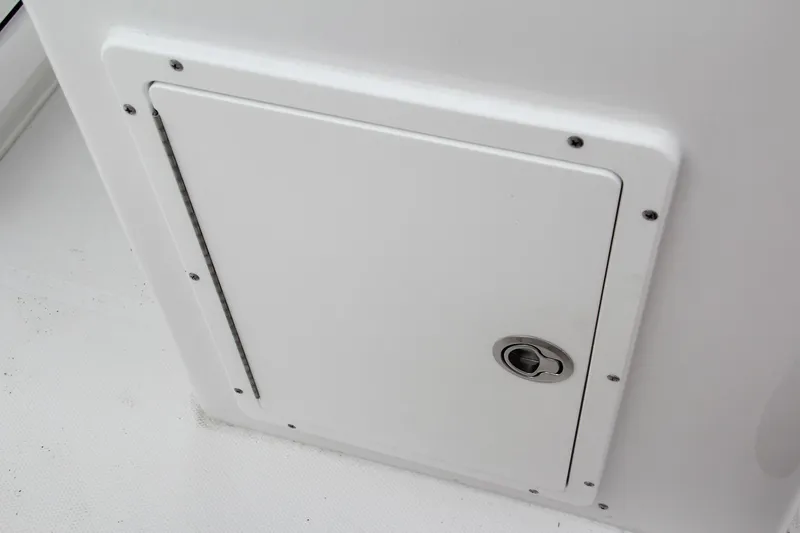 Slide: The Image of 2024 Sea Hunt Ultra 239 SE storage compartment with secure latch. - 25