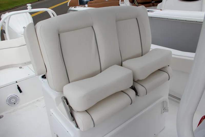 Slide: The Image of 2024 Sea Hunt Ultra 239 SE boat seating with cushioned backrests and armrests. - 27