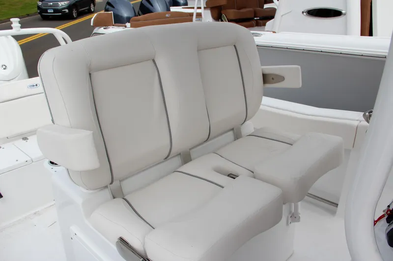 Slide: The Image of 2024 Sea Hunt Ultra 239 SE boat seating with white cushioned seats and armrests. - 28