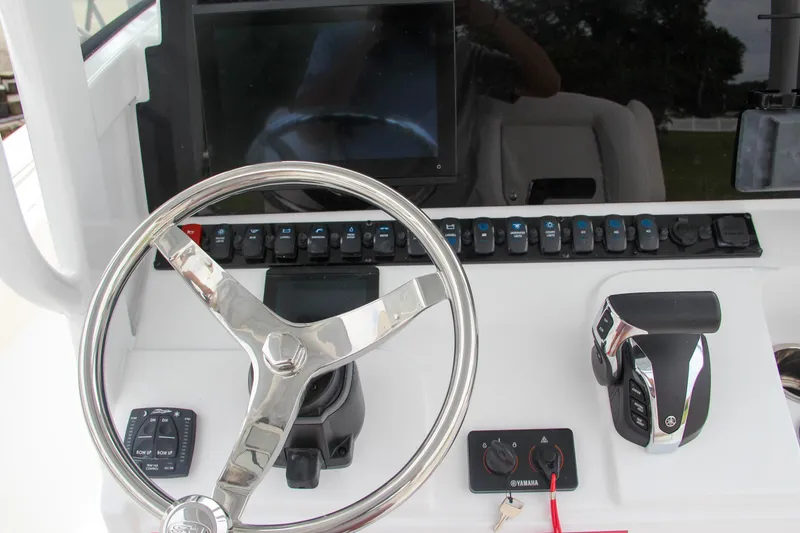 Slide: The Image of 2024 Sea Hunt Ultra 239 SE boat dashboard with steering wheel and controls. - 31