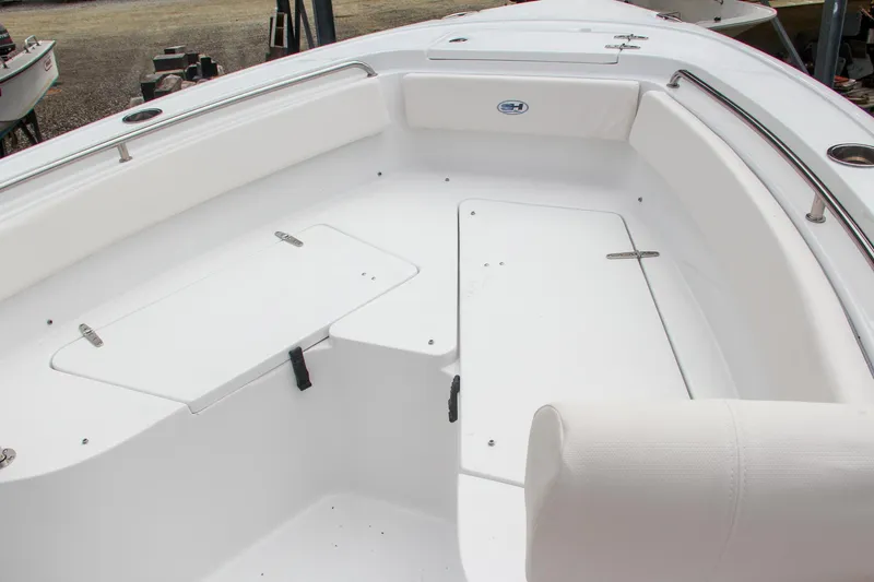 Slide: The Image of 2024 Sea Hunt Ultra 239 SE boat interior with white seating and storage compartments. - 35