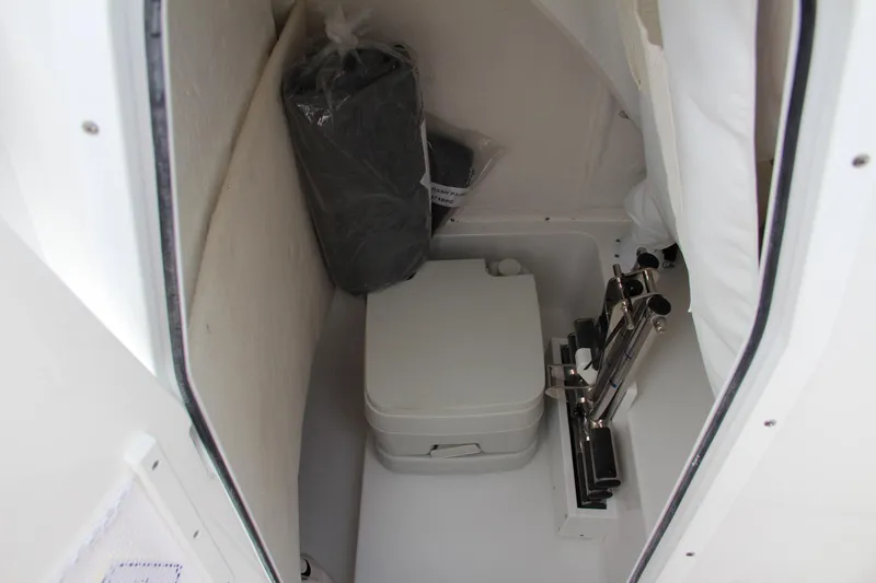 Slide: The Image of 2024 Sea Hunt Ultra 239 SE boat interior with compact toilet. - 41