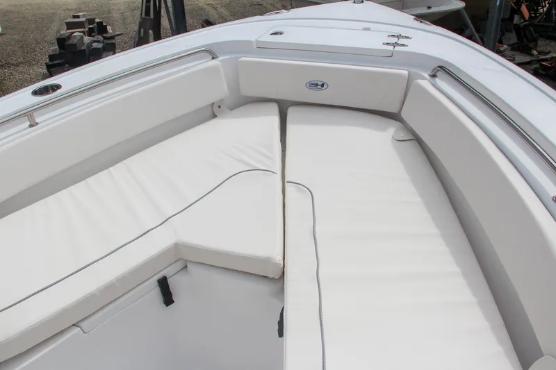 Slide: The Image of 2024 Sea Hunt Ultra 239 SE boat with white cushioned seating. - 42