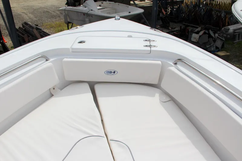 Slide: The Image of 2024 Sea Hunt Ultra 239 SE boat bow seating area with white cushions. - 43