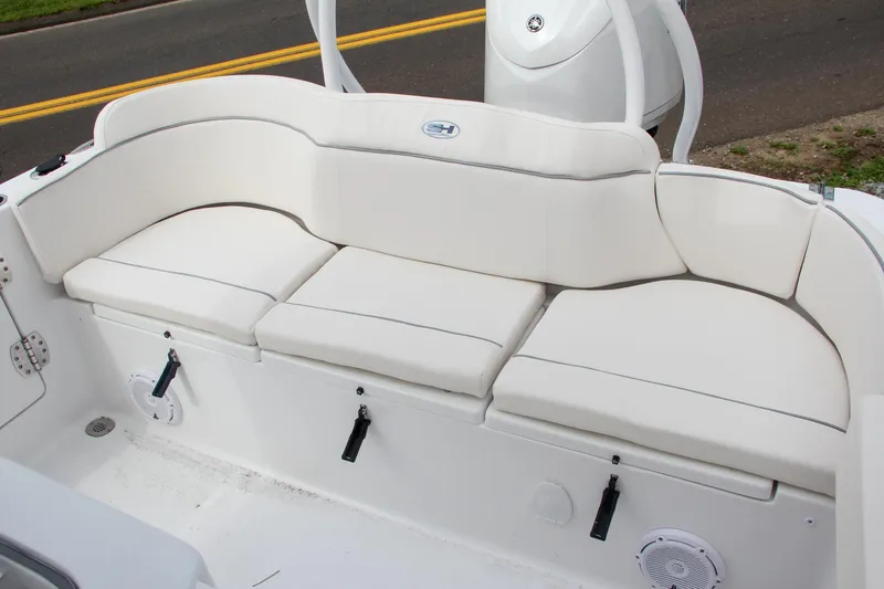 Slide: The Image of 2024 Sea Hunt Ultra 239 SE boat with white cushioned seating. - 44