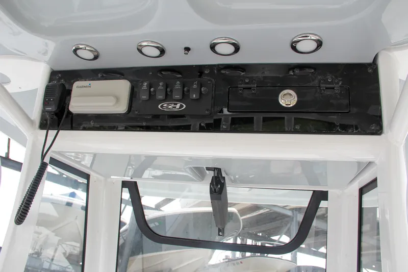 Slide: The Image of 2024 Sea Hunt Ultra 239 SE console with electronics and controls. - 45